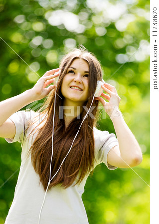 Young woman concentrating on her music 11238670