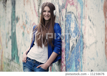 Trendy young woman listening to music 11238676