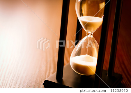 Hourglass with the sand running through 11238950
