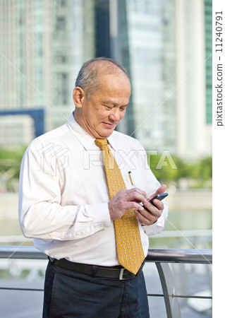 Elderly businessman making a call on smart phone Elderly businessman making a call on smart phone 11240791