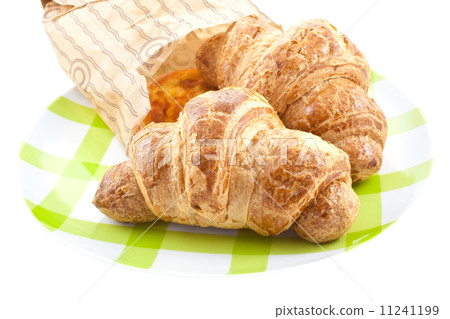 croissants in paper pack on plate isolated croissants in paper pack on plate isolated 11241199