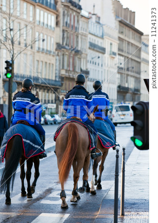 french mounted gendarmerie on a street of Paris 11241373