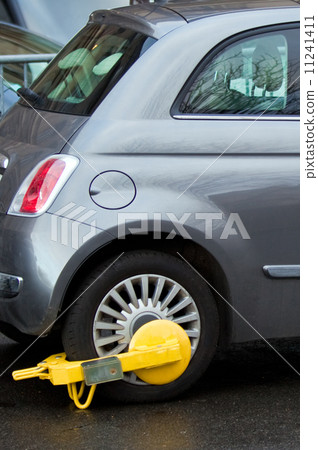 street cuff on a wheel of wrong parking car street cuff on a wheel of wrong parking car 11241411