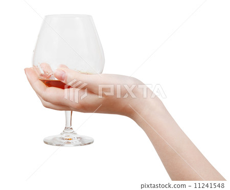 glass with brandy in hand isolated 11241548