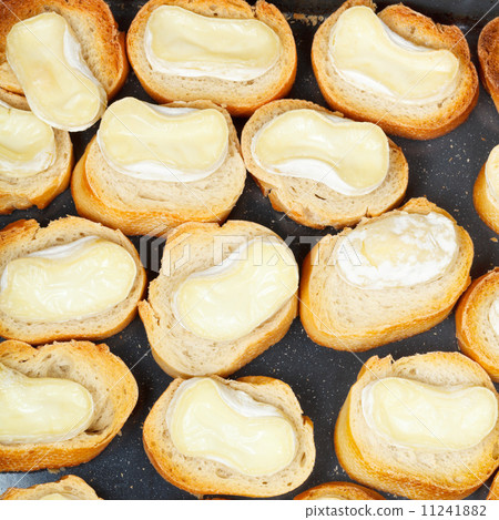 top view of roasted bread with melted goat cheese top view of roasted bread with melted goat cheese 11241882