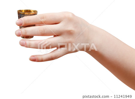 hand holds little metal cup with spirit 11241949