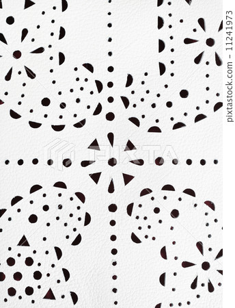 punched paisley ornament on white leather 11241973