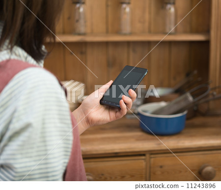 Housewife and smartphone 11243896