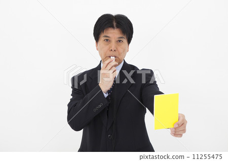 A man issuing a yellow card A man issuing a yellow card 11255475