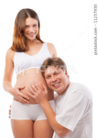 Husband listening to his wife's belly 11257930