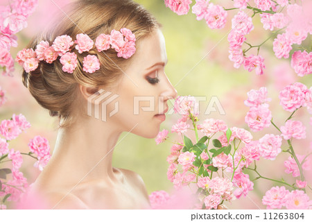 Beauty face of young beautiful woman with pink flowers in her hair Beauty face of young beautiful woman with pink flowers in her hair 11263804