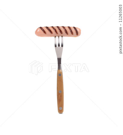 Grilled sausage on a fork. 11265003