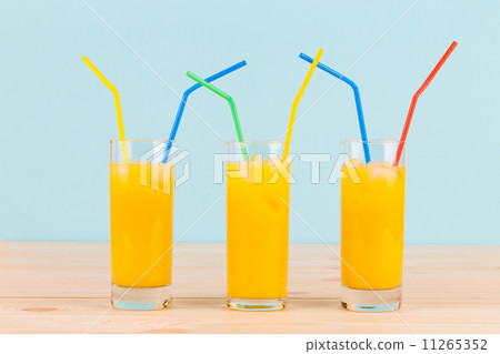 Orange juice on wooden table. 11265352