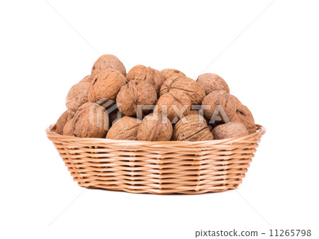 Wicker basket full of walnuts. 11265798