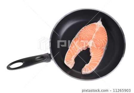 Salmon steak on frying pan. 11265903
