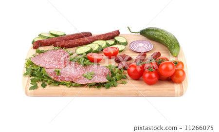 Sausage salami and vegetables on wooden platter. Sausage salami and vegetables on wooden platter. 11266075