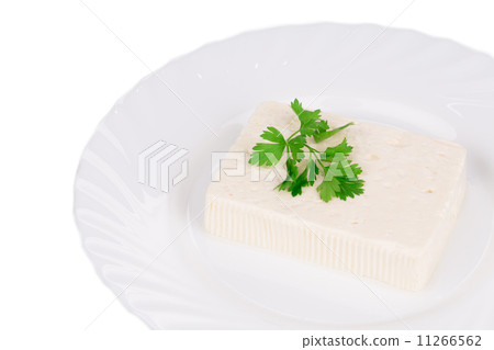 Tofu with parsley on a plate. Tofu with parsley on a plate. 11266562