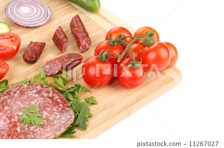 Sausage salami and vegetables on wooden platter. 11267027