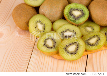 Sliced kiwi on cutting board. Sliced kiwi on cutting board. 11267211