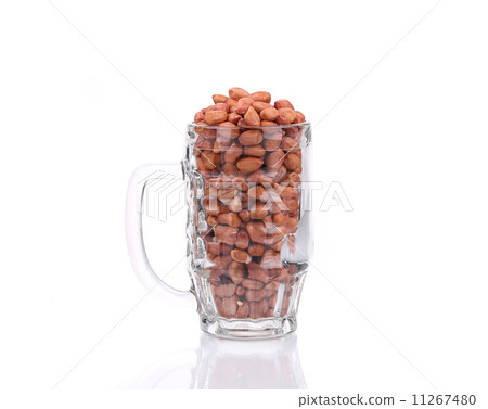 Beer glass full of peanuts. 11267480