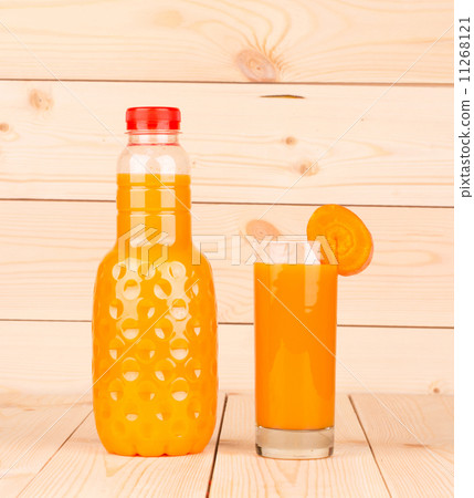 Close up of carrot juice in glass and bottle. 11268121