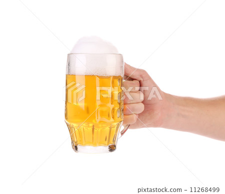 Mug of beer with foam in hand. Mug of beer with foam in hand. 11268499