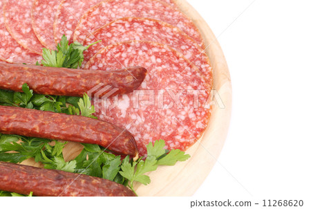 Composition of sausages on wooden platter. 11268620