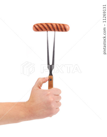 Hand holding barbecue fork. 11269131