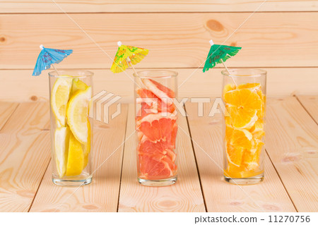 Lemon orange and grapefruit in glass on table. Lemon orange and grapefruit in glass on table. 11270756