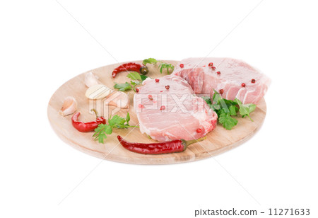 Raw meat on a wooden platter. 11271633