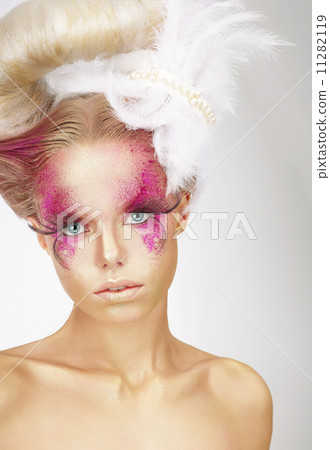 Showy Woman with Fuzzy Feathers and Fantastic Art Makeup 11282119