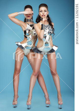 Extravagance. Two Heeled Women in Futuristic Clubwear. Hangouts Extravagance. Two Heeled Women in Futuristic Clubwear. Hangouts 11282191