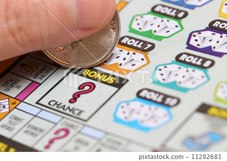 Woman scratching lottery ticket called Monopoly. Woman scratching lottery ticket called Monopoly. 11282681