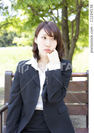 Business women troubled at the park 11284536