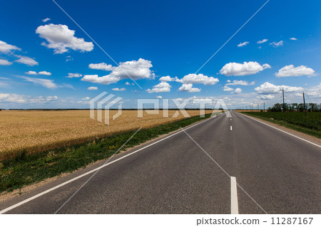 Blue sky with clouds over asphalt road Blue sky with clouds over asphalt road 11287167