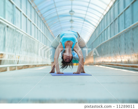 Woman doing yoga stretching bridge pose Woman doing yoga stretching bridge pose 11289011