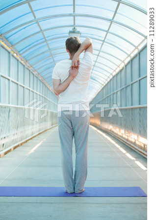 Man doing stretching yoga exercise 11289033