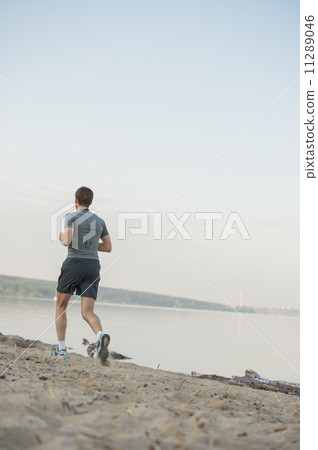 Male running beach 11289046