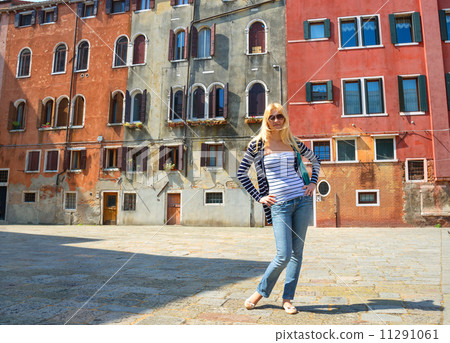 Attractive girl on a background of old houses in Venice, Italy 11291061