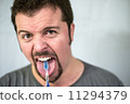 Angry man brushing his tongue 11294379