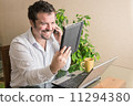 Young man working at home 11294380