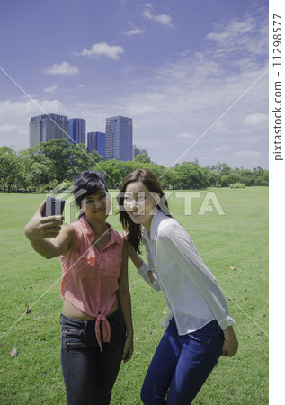 young beautiful Asian woman taking a self portrait with camera m 11298577