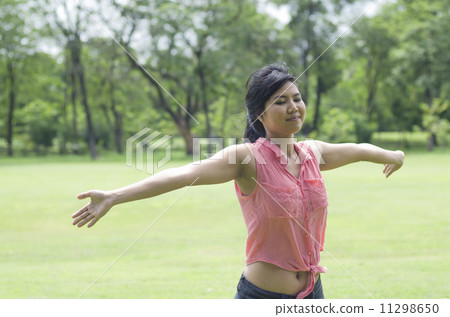 Happiness freedom concept. Woman happy smiling with arms up, asi Happiness freedom concept. Woman happy smiling with arms up, asi 11298650