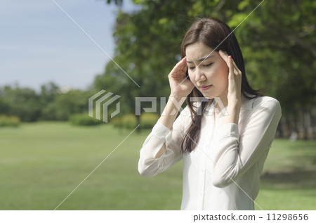 Young Asian woman suffering with headache 11298656