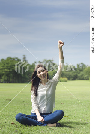 Happiness freedom concept. Woman happy smiling with arms up, asi Happiness freedom concept. Woman happy smiling with arms up, asi 11298702