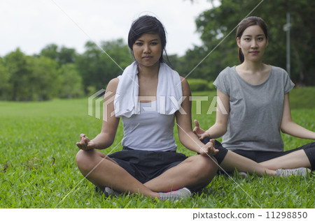 Attractive Healthy Asian Women meditating in the park 11298850
