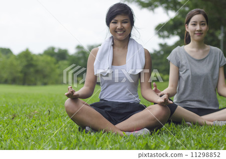 Attractive Healthy Asian Women meditating in the park 11298852