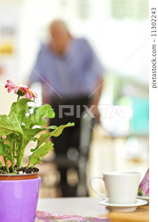 Senior man using a walker in a retirement home Senior man using a walker in a retirement home 11302243
