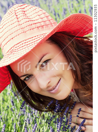 Beautiful young woman with hat in a lavender field 11302935