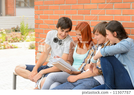 Student friends studying together outside campus Student friends studying together outside campus 11307787